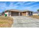 Desirable property featuring a 3-car garage and a spacious concrete driveway at 11869 Newgate Ave, Port Charlotte, FL 33981