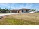 Charming home featuring a spacious driveway, two-car garage, and inviting curb appeal at 11869 Newgate Ave, Port Charlotte, FL 33981
