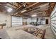 Spacious garage with high ceilings and exposed wooden beams, suitable for multiple vehicles and storage at 11869 Newgate Ave, Port Charlotte, FL 33981