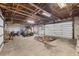 Large garage featuring exposed wooden beams, ample storage, and space for recreational vehicles and equipment at 11869 Newgate Ave, Port Charlotte, FL 33981