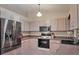 Well-equipped kitchen with stainless steel appliances, light wood cabinets, and a tile backsplash at 11869 Newgate Ave, Port Charlotte, FL 33981