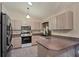 Functional kitchen with stainless steel appliances, ample cabinets, and tile flooring at 11869 Newgate Ave, Port Charlotte, FL 33981