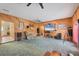 Spacious living area with wood paneled walls, ceiling fans, and outdoor access at 11869 Newgate Ave, Port Charlotte, FL 33981