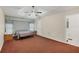 Main bedroom with ceiling fan and ensuite bathroom access at 11869 Newgate Ave, Port Charlotte, FL 33981