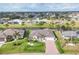 An aerial view of a single-Gathering home with a well-maintained lawn and mature trees at 119 Fairway Rd, Rotonda West, FL 33947