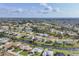 Scenic aerial view of a residential community featuring a golf course and waterfront homes on canals at 119 Fairway Rd, Rotonda West, FL 33947