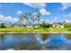 A serene view of the backyard with a canal running through it, lined with mature trees at 119 Fairway Rd, Rotonda West, FL 33947