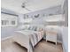 Comfortable bedroom featuring a queen bed, neutral colors, and shelf decor at 119 Fairway Rd, Rotonda West, FL 33947