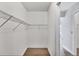 Walk-in closet featuring open shelving and a door to the hallway at 119 Fairway Rd, Rotonda West, FL 33947