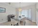 Dining room features a modern chandelier, glass-top table, and large window with sheer curtains at 119 Fairway Rd, Rotonda West, FL 33947