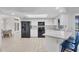 Spacious kitchen boasts sleek black appliances, white cabinetry, and a breakfast bar with seating at 119 Fairway Rd, Rotonda West, FL 33947