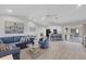 Open concept living room connecting to the kitchen and patio, featuring stylish furnishings and decor at 119 Fairway Rd, Rotonda West, FL 33947