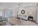 Bright living room with tile floors, a ceiling fan, and comfortable seating with a glass coffee table at 119 Fairway Rd, Rotonda West, FL 33947