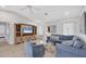 Inviting living room with vaulted ceilings, comfortable blue seating, and stylish decor at 119 Fairway Rd, Rotonda West, FL 33947