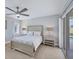 Bright main bedroom with neutral decor, fan, and sliding door access to the pool and backyard at 119 Fairway Rd, Rotonda West, FL 33947