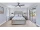 Serene main bedroom with a neutral color scheme, ceiling fan, and sliding glass door to the pool area at 119 Fairway Rd, Rotonda West, FL 33947