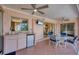 Covered patio with ceiling fans, a mini-fridge, and a table with four chairs at 119 Fairway Rd, Rotonda West, FL 33947
