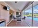 Pool-side patio with a table, chairs, and a view of the screened-in pool at 119 Fairway Rd, Rotonda West, FL 33947