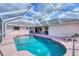 Outdoor in-ground pool with a screened enclosure and patio area at 119 Fairway Rd, Rotonda West, FL 33947