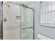 Elegant glass-enclosed shower with white subway tile and modern fixtures at 119 Fairway Rd, Rotonda West, FL 33947