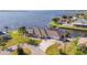 Beautiful aerial view of a waterfront home, featuring lush greenery, a circular driveway and boat dock at 12445 Krome Ave, Port Charlotte, FL 33981