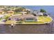 Waterfront property with a private dock, boat lift, screened-in pool, and meticulously maintained landscaping at 12445 Krome Ave, Port Charlotte, FL 33981