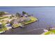 Waterfront property featuring a private dock, boat lift, screened-in pool, and stunning views of the water at 12445 Krome Ave, Port Charlotte, FL 33981