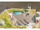 Aerial shot of waterfront home featuring a private pool, lush landscaping, and boat dock at 12445 Krome Ave, Port Charlotte, FL 33981