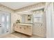 Bright bathroom with a large mirror, vanity and door to outside at 12445 Krome Ave, Port Charlotte, FL 33981