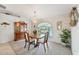 Formal dining room with chandelier, hutch, large window and wallpaper at 12445 Krome Ave, Port Charlotte, FL 33981