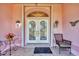 Inviting entryway with decorative double doors, stylish lighting, and tiled flooring at 12445 Krome Ave, Port Charlotte, FL 33981