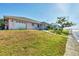 Waterfront property featuring a well-manicured lawn, direct water access, and an enclosed pool area at 12445 Krome Ave, Port Charlotte, FL 33981