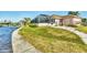 A waterfront home with beautiful lawn, enclosed pool, and water access at 12445 Krome Ave, Port Charlotte, FL 33981