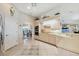 Bright kitchen features neutral cabinetry, tile floors and adjacent dining area with arched entry at 12445 Krome Ave, Port Charlotte, FL 33981
