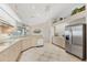 Bright kitchen featuring tile floors, neutral colored cabinetry and modern appliances at 12445 Krome Ave, Port Charlotte, FL 33981