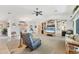 Spacious living room with neutral carpeting, waterfront view, and built-in shelving units at 12445 Krome Ave, Port Charlotte, FL 33981