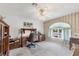 Cozy office space with a ceiling fan, desk, chair and soft lighting at 12445 Krome Ave, Port Charlotte, FL 33981