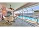 Enclosed pool area featuring a waterfront view, swimming pool, hot tub and a seating area at 12445 Krome Ave, Port Charlotte, FL 33981