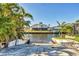 Waterfront backyard featuring boat lift, seawall, and a stunning view at 12445 Krome Ave, Port Charlotte, FL 33981