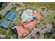 Aerial view of the clubhouse, community pool, tennis courts, bocce ball, and activities at 1318 Ballota Ln, North Port, FL 34289