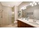 Bright bathroom with dual sinks, walk-in shower and coastal decor at 1318 Ballota Ln, North Port, FL 34289