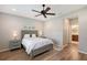 Primary bedroom featuring neutral walls, ensuite bathroom and wood-look flooring at 1318 Ballota Ln, North Port, FL 34289