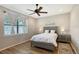 Bedroom with ceiling fan, wood-look flooring and lovely decor at 1318 Ballota Ln, North Port, FL 34289