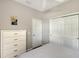 Bright bedroom featuring a dresser, closet, and a comfortable bed, providing ample storage and space at 1318 Ballota Ln, North Port, FL 34289