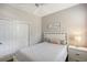 Cozy bedroom with a closet, white bed, bedside table and lamp creating a relaxing and inviting atmosphere at 1318 Ballota Ln, North Port, FL 34289