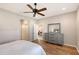 Spacious bedroom showing ensuite bathroom and a peak into the living room at 1318 Ballota Ln, North Port, FL 34289