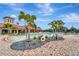 Inviting community pool area surrounded by brick pavers, tropical landscaping and palm trees at 1318 Ballota Ln, North Port, FL 34289