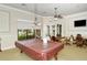 Spacious game room featuring a pool table, ceiling fan, and natural light creating a welcoming atmosphere at 1318 Ballota Ln, North Port, FL 34289