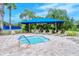 Cozy community hot tub with covered lounge area and lush greenery at 1318 Ballota Ln, North Port, FL 34289