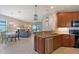 Open concept kitchen with granite counters open to dining and living room at 1318 Ballota Ln, North Port, FL 34289